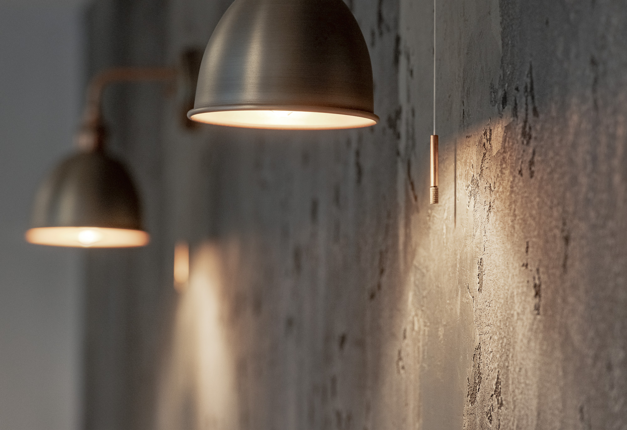 decorative wall light against venetian plaster wall in man cave garden studio horsham
