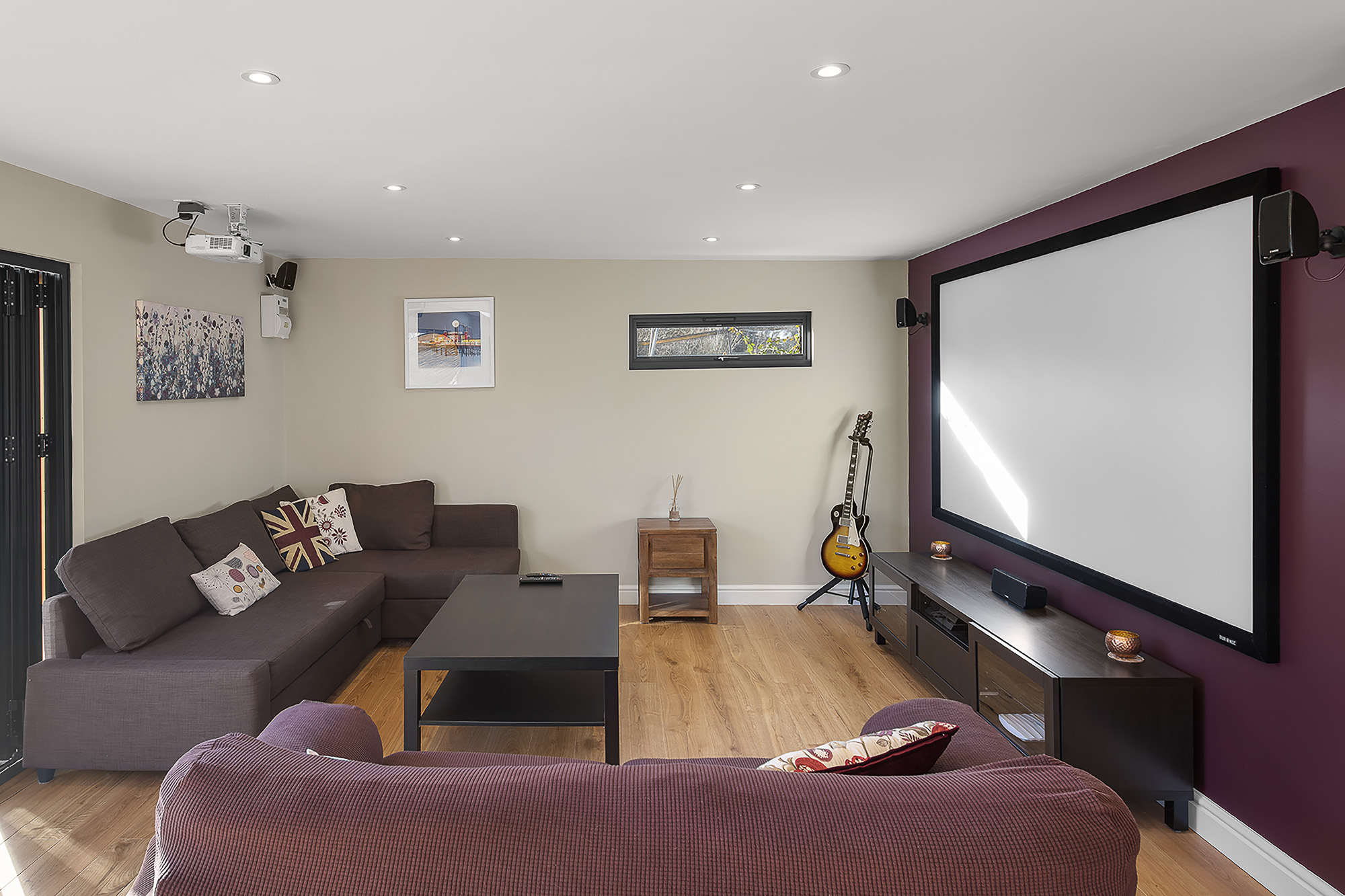 garden room mancave interior shot with projector and hangout area